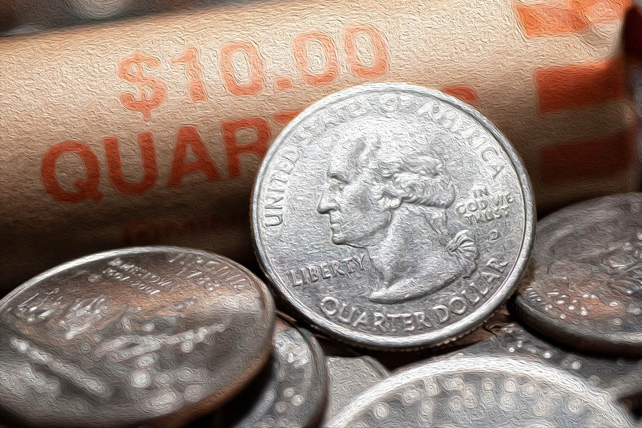 Close up of a quarter leaning against a roll of quarters.